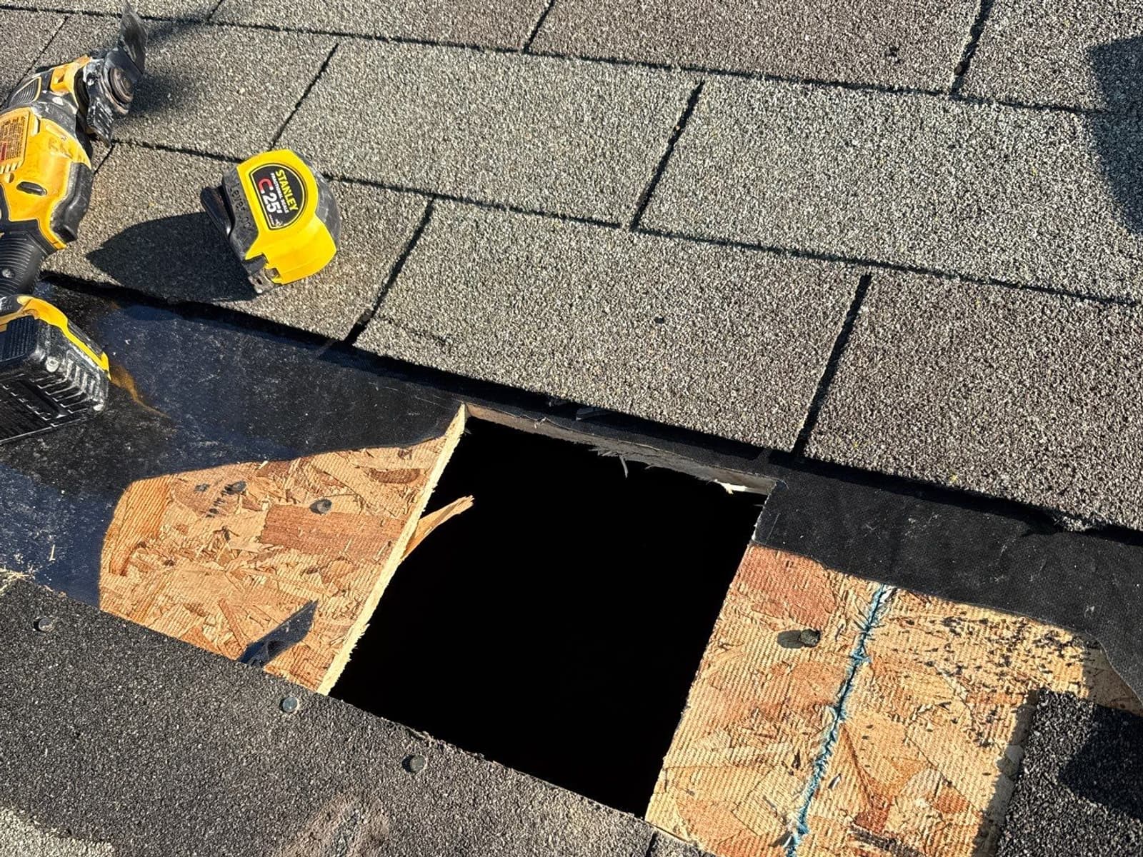 A roof repair in progress - shingles cut back and the decking opened up around the leak.