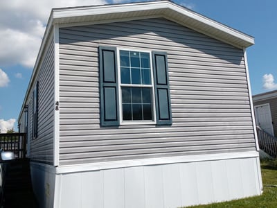After: the same home washed down, with bright white trim and skirting.